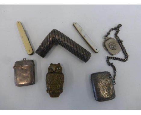 An assortment of vesta cases, one in the form of an owl, plus two silver. Also a rope-twist silver walking stick handle.