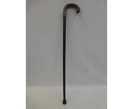 An ebonised walking stick, the handle covered in Finland silver, dated 1947.