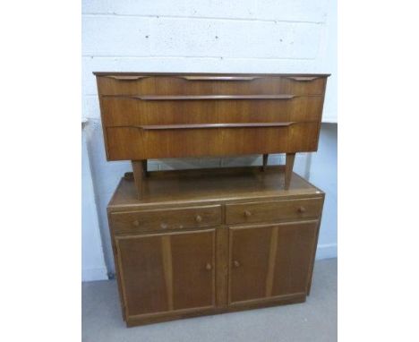 A G-Plan style sideboard with retail label- "Beeanies Furniture", and a light oak cabinet of two drawers over a cupboard base