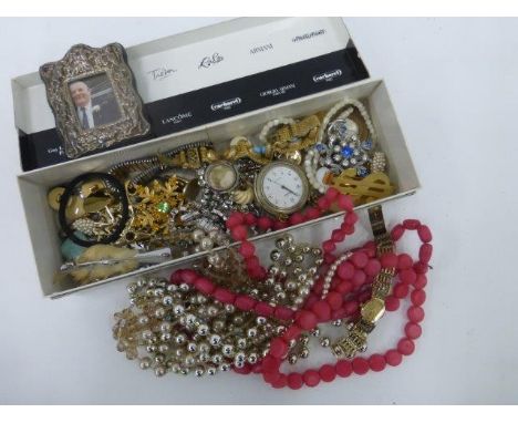 An assortment of costume jewellery including a 9ct gold locket and a silver gilt Rotary lady's wristwatch.