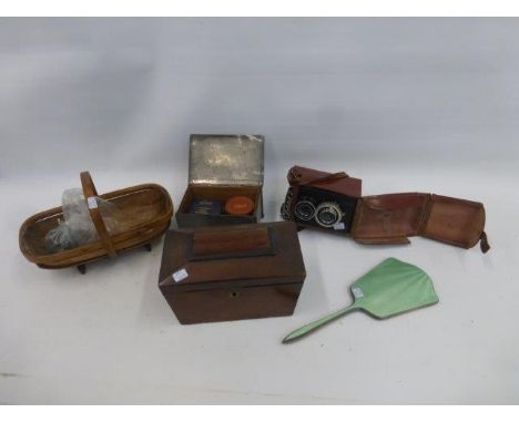 A miniature trug, a tea caddy, a Lubitel Z Camera, a silver and enamel hand mirror, and a pewter lidded box with the inscript