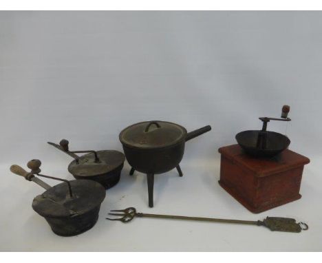 A cast iron tripod saucepan, a coffee grinder, a toasting fork etc..