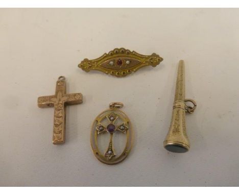 An assortment of gold brooches and pendants, two set with seed pearls and a ruby.