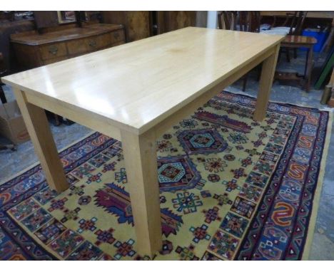 A Contemporary light oak dining table with concave shaped supports.