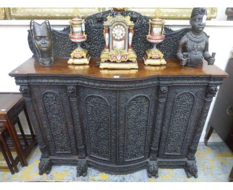 A good quality 19th Century Anglo-Indian hardwood part bow fronted sideboard of small proportions, heavily and ornately carve