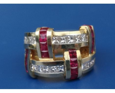 A ruby &amp; diamond set 18K cocktail ring of modern double band form, set with numerous small Princess cut diamonds &amp; sq