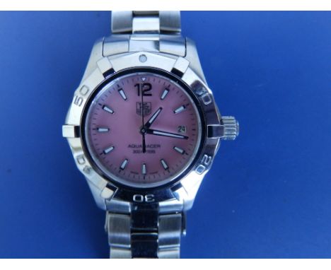 A boxed lady's stainless steel Tag Heuer Aquaracer bracelet wrist watch with pink pearl dial, baton numerals, centre seconds,