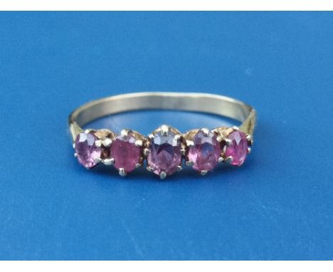 A five stone graduated claw set ruby ring on 18ct shank.  Finger size O.