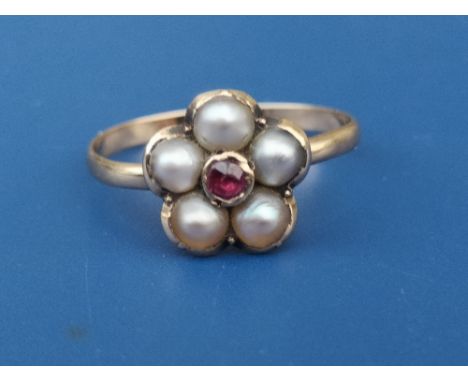 A Georgian pearl flowerhead cluster set gold ring with central garnet.  Finger size N/O.