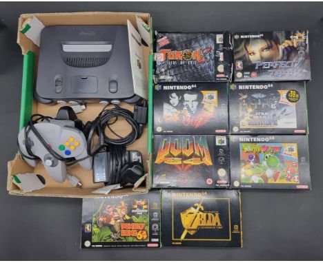 Video Games:&nbsp;a grey Nintendo 64 console with controller, jumper pak, and cables; together with 8 games including 'The Le