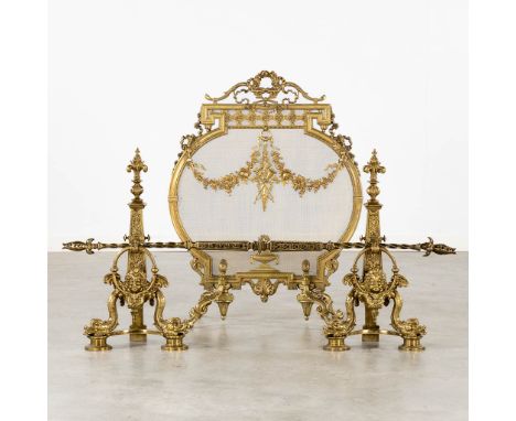 A pair of fireplace bucks and a firescreen, bronze in Louis XVI style.The first half of the 20th century.&nbsp;Dimensions: (L