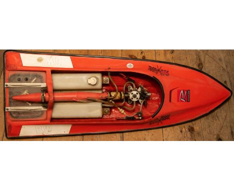 A multi-racer pond boat with orange fibreglass body and fitted with a 3.5cc Novarossi glow plug (Nitro) engine, with water co