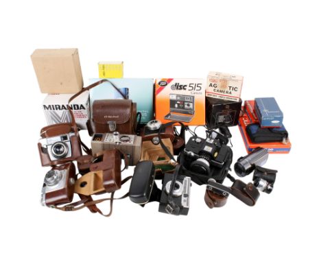 A collection of assorted vintage cameras and accessories. Including Minolta 110 Zoom SLR and a Canon Powershot S20 digital, e