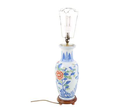 A Chinese ceramic table lamp. Raised on a circular wood base with bird and floral decoration. Height 41cm.