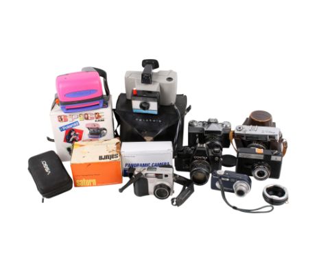 A large quantity of assorted film cameras and accessories. Including Polaroid Spicecam, Zenit-E, cables, etc. * This lot is b