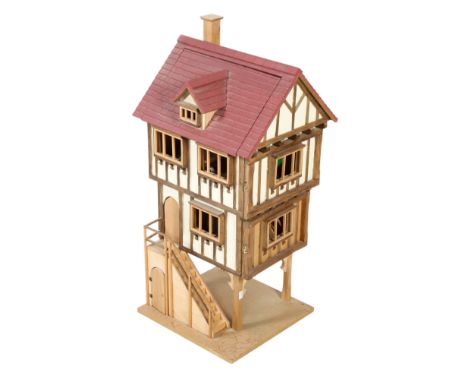 A Tudor framed style dolls house with contents. Two floors with outer staircase, with a book, 'floor tiles' and some furnitur