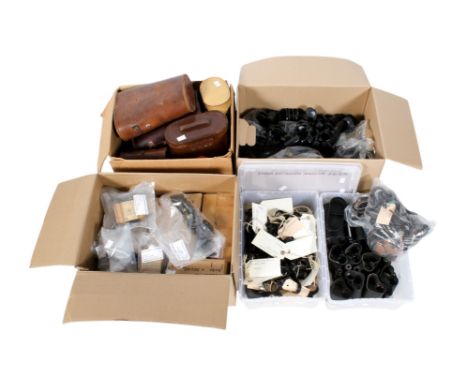 Four boxes of assorted binocular components and spares. Including eye lenses, cases, etc.