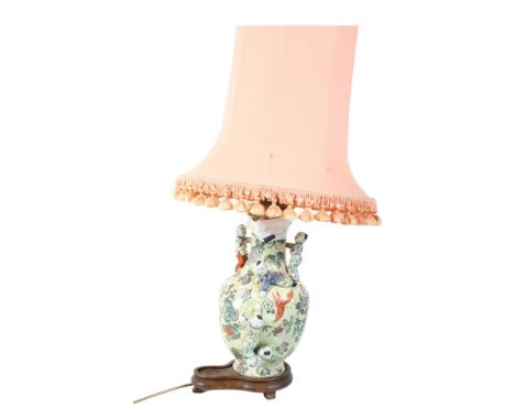A Chinese 'climbing children' ceramic table lamp. Raised on a hardwood base, H41cm. (AF)  Condition Report: Damage to some of