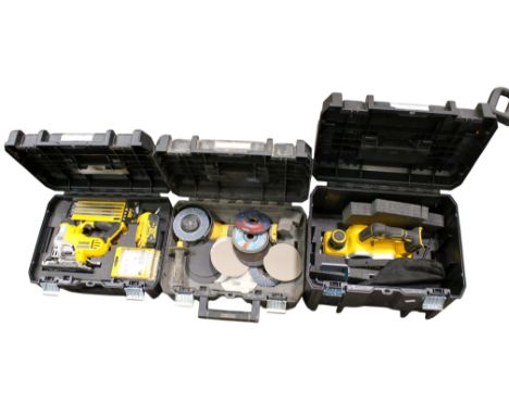 A group of three cordless Dewalt power tools, all cased. Including a jigsaw DCS331, grinder DCG405 and a DCP580 planer