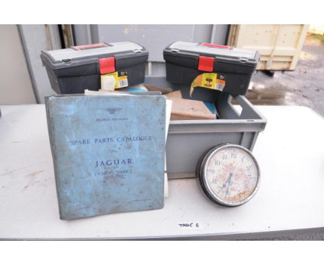 A box of photographic lamps, Lucas spot light, x2 smiths clock, spares catalogue for Jaguar MK2.4 Mk2