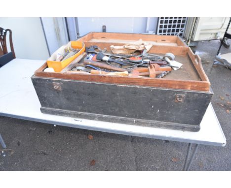 A wooden tool chest containing various tools.