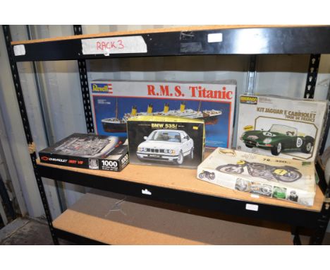 Four model kits including Titanic, car, motorbike and Chevrolet engine puzzle.