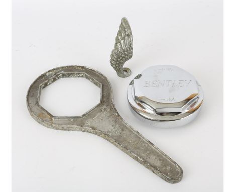 Bentley chrome hub cap nut marked OFF-On, with cast alloy spanner RF 3851 and two winged car ornaments  