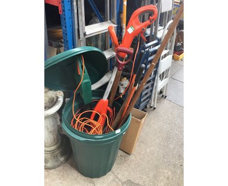 A green plastic bin with garden tools inc hedge trimmer, strimmer, etc and a skateboard 