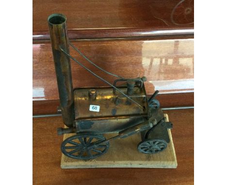 A model of Stephenson's Rocket on wooden base. Est. £10 - £15.