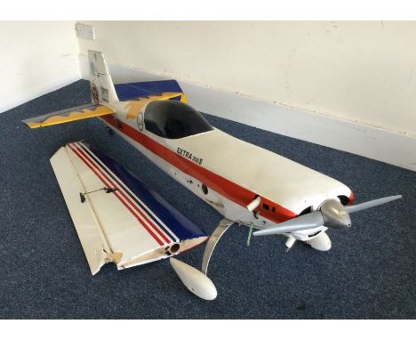 A large scratch built model Extra 300 aircraft with engine in red, white and blue. Est. £30 - £50.