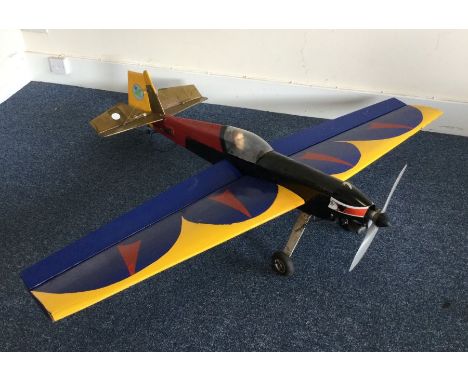 A scratch built model Extra 200 aircraft with blue, red and yellow wings. Est. £50 - £80.