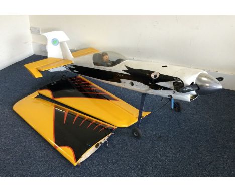 A large scratch built model Extra 300 aircraft with engine in white, black and yellow. Est. £30 - £50.