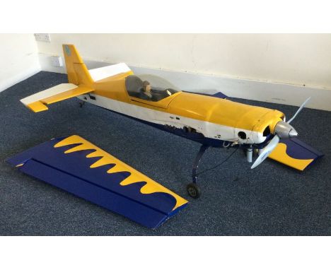 A large scratch built model Extra 300 aircraft with engine in blue and yellow. Est. £30 - £50.