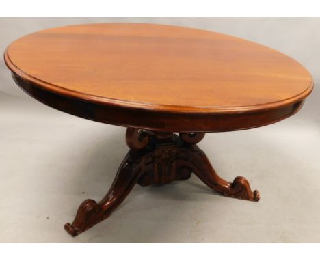 An Eastern hardwood dining table, in early Victorian style, the circular top with a moulded edge on a central hexagonal and c