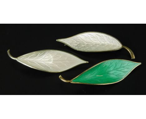 Three Scandinavian enamel brooches, to include two David Andersen Norwegian leaf brooches with white and green enamel decorat