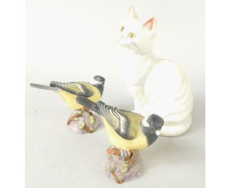 Two Royal Worcester Great Tits, and a Beswick model of a cat.