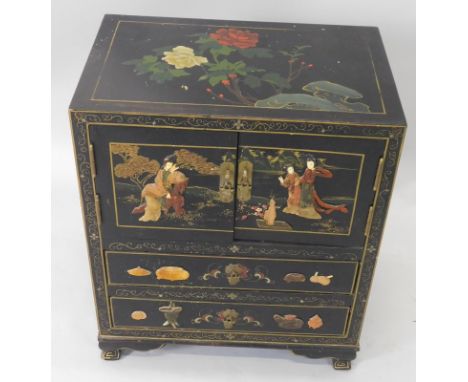 An oriental black lacquer side cabinet, with shibayama type decoration in soapstone etc., with a caddy top above two doors an