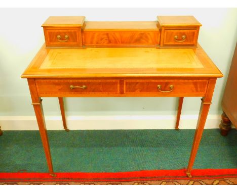 An Edwardian mahogany and satinwood crossbanded writing table, the top with a central hinged section enclosing letter rack, i