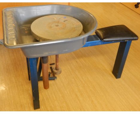 A seated treadle kick potter's wheel, with blue enamel decoration, etc.  Viewing strictly by appointment with saleroom