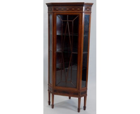 An Edwardian mahogany and marquetry corner display cabinet, with a moulded cornice above a lozenge decorated frieze, an astra