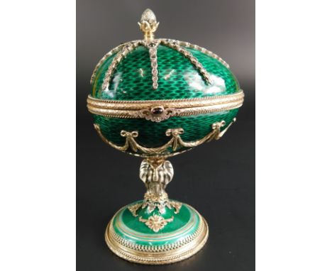 A Fabergé silver and green guilloche enamel egg, the hinged lid with a stylised pineapple finial and a spider shaped mount in