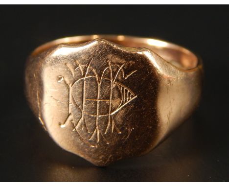 A 9ct gold signet ring, with engraved shield of initials and a symbol, 4.9g all in. 