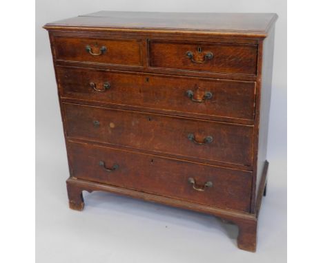 A North Country oak and mahogany crossbanded and chequer banded chest of drawers, the top with a moulded edge above two short
