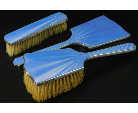 A George VI silver three piece dressing table set, each decorated with blue guilloche enamel, Birmingham 1938