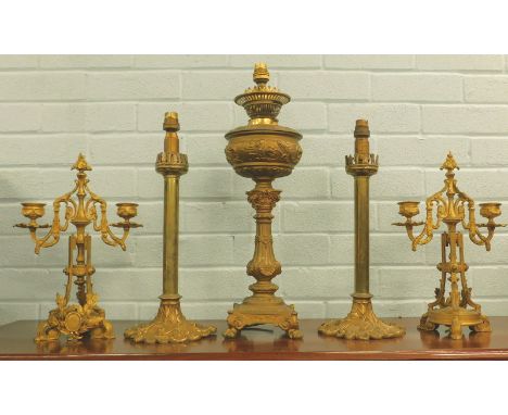 A collection of late 19thC French and other gilt metal items, to include an oil lamp on a square base, a pair of two branch c