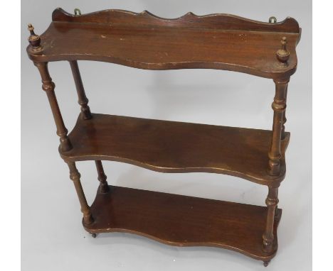 A mahogany three tier wall shelf, with spindle turned supports, 55cm wide.