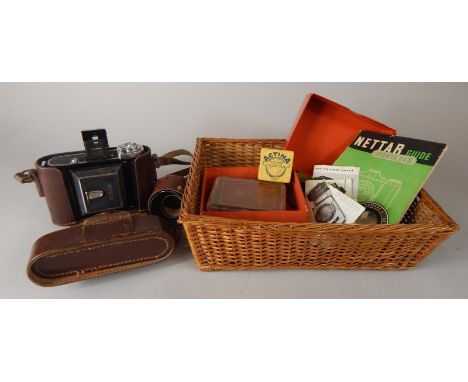 A collection of photographic items, to include an Ikonta camera manual etc.