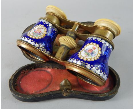 A pair of French gilt metal opera glasses,  with enamel decoration of flowers on a blue ground, the eye piece stamped Jumelle