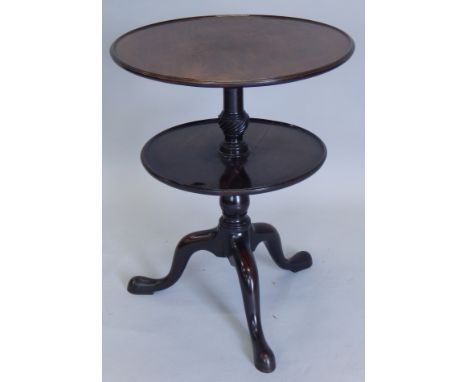 A mahogany dumb waiter, with two circular dished sections, on turned column and tripod base, George III but adapted, top tier