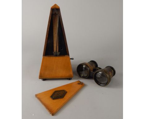 An early 20thC polished mahogany Paquet 1946 pattern metronome, of tapering outline, 24cm high and a pair of opera binocuolar